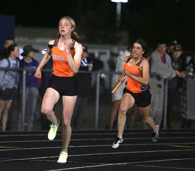 Douglas High's Julianne James, with baton, and Bliss Moody hit the first corner of the Class 5A girls' regional 4x100 competition Friday night. James, Moody, Kaylee Bradford and Jessica James posted a school record in the event, finishing in 49.51