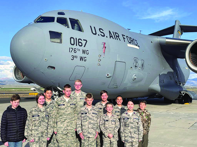 Civil Air Patrol cadets pose in front of a C-17 transport aircraft in Minden as part of training.