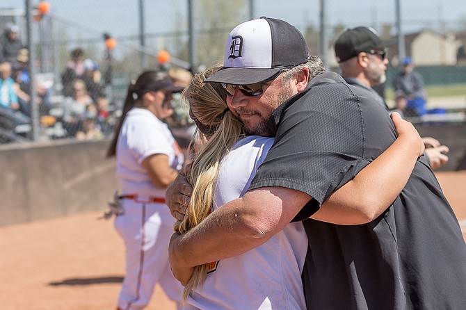 Douglas High softball coach John Glover hugs his daughter, Emma, on senior night. The Tiger softball team fell in the Class 5A state championship to Green Valley, ending the season as the state runner-up.
