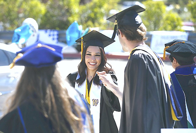 WNC faculty members congratulate graduate Julia Cruz during the 2021 Western Nevada College drive-through commencement ceremony in Carson City.