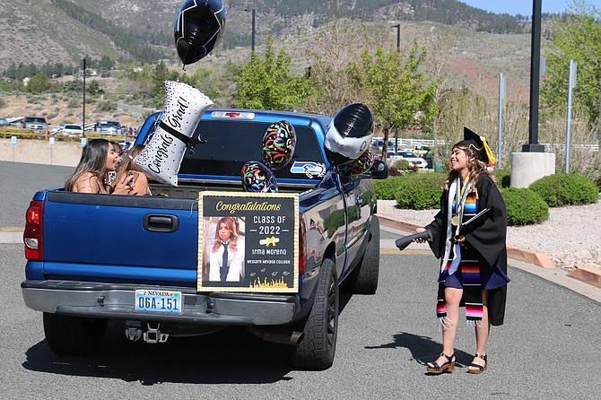 Irma Moreno of Carson City, right, greets family and friends in their vehicle after picking up her associate of arts degree May 23, 2022 during graduation at Western Nevada College in Carson City.