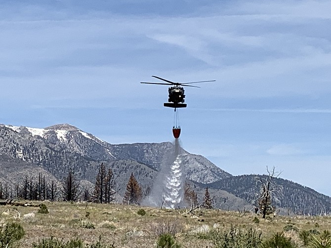 A Nevada Army National Guard helicopter conducts a practice water drop near Indian Creek Reservoir in Alpine County on May 18. Firefighters are preparing for a difficult fire season and residents should be doing the same.
