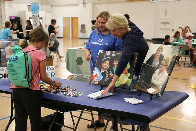 Northern Nevada Dream Center Executive Director Susan Sorenson, right, and Director of Programs and Volunteers Bethany Herzing brief a student May 25, 2022 at a Carson City community mental health fair.
