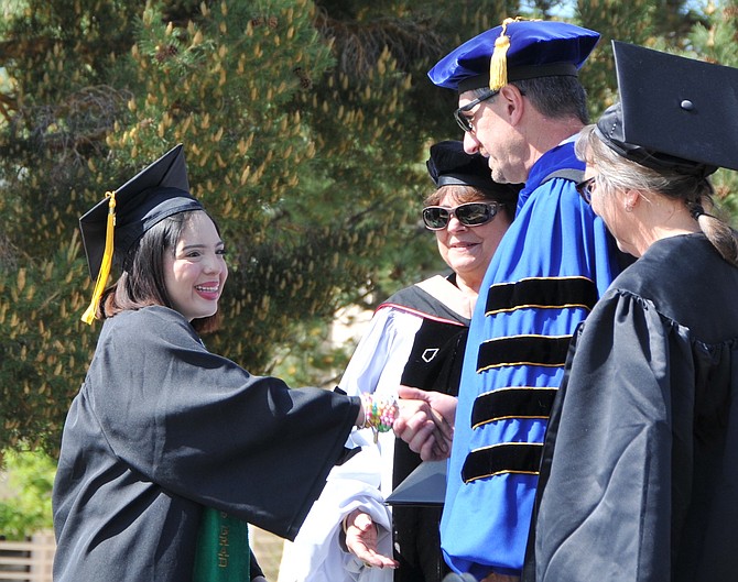 Nereida Rivera of Carson High School receives congratulations from Western Nevada College Interim President J. Kyle Dalpe on May 23 in Carson City. The Jump Start student earned an Associate of Arts degree before receiving her high school diploma.