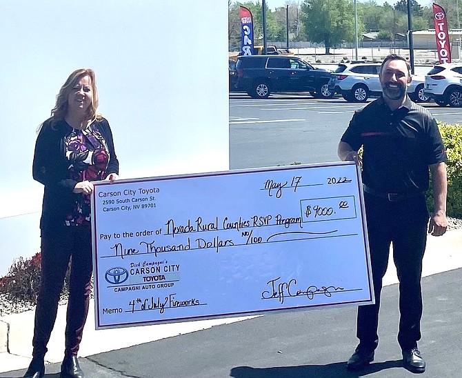 RSVP CEO Molly Walt accepts a donation from Dick Campagni’s Carson City Toyota General Manager Jeff Campagni.
