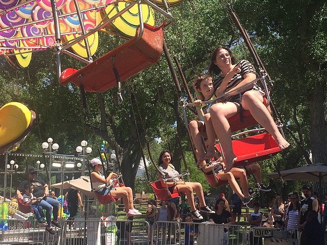 Carson City parents and children ride a star flyer at the 2021 Nevada State Fair.