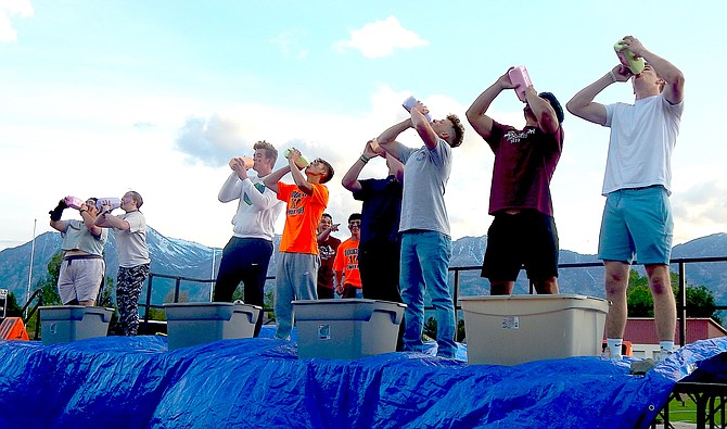 Guess what the buckets are for at Friday night's Mountain Madness Milk Chugging contest at Douglas High School.