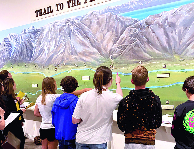 Carson Valley Middle School students take notes in front of the big mural depicting Carson Valley at the Carson Valley Museum & Cultural Center