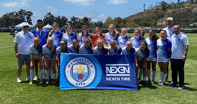 The Battle Born Futbol Club 05/06 Girls Academy team poses for a photo at the 2022 Manchester City Cup in San Diego over the past weekend. Pictured in the bottom row, from left to right, are Kylee Lash, Olivia Childs, Alyssa Tomita, Rachel Radow, Aleeah Weaver, Jillian Russell, Ellie Boggs, Seara Macpherson and Johanna Ruelas. In the top row from left to right are coach Richie McGuffin, sporting director Andrew Robles, Zoe Baligad, Sky Rasmussen, Reese Ballingham, Elizabeth Mehrtens, Kaylee Bradford, Grace McGuffin, Rylie Lovec, coach Darin Bourgeois and coach Hector Ruelas.