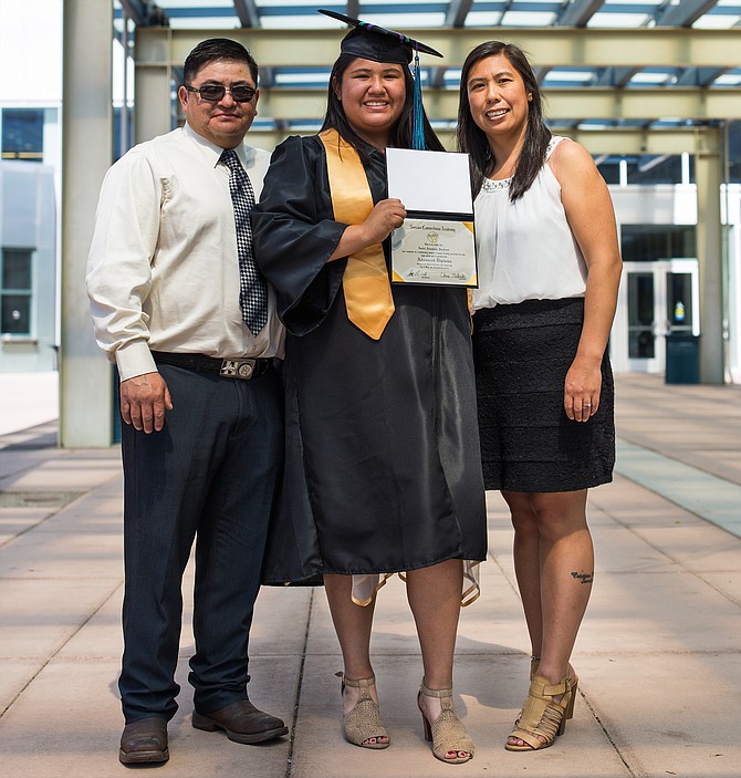 Isabel Sandoval poses with her parents on graduation day from Nevada Connections Academy.
