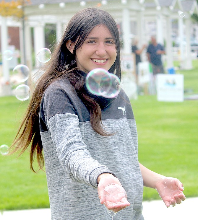 Soon-to-be Douglas High School freshman Sienna Maita catches bubbles on Saturday at the Carson Valley Museum & Cultural Center.