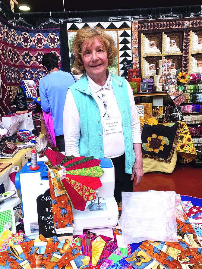Sandra Sulliva, who has quilted since 1984, stands with her creations at the Carson Valley Quilt Show at the Douglas County Community & Senior Center on Saturday.