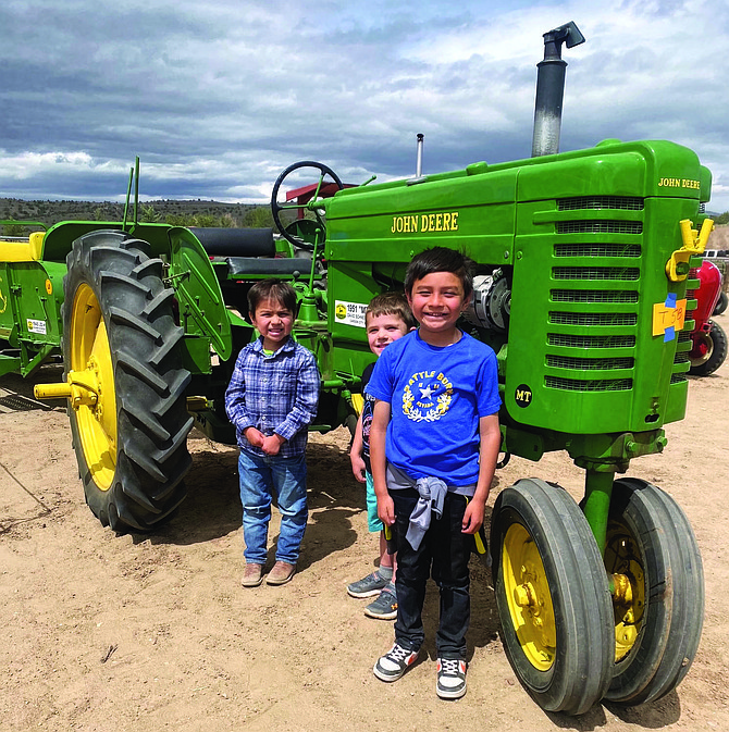 Aaron, Braxton and Andrew Lister pose in front of their favorite tractor at the Antique Tractor Power Show on Saturday at the Douglas County Fairgrounds in Gardnerville.