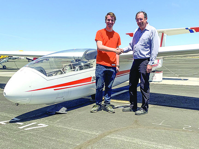 Designated Pilot Examiner Mark Montague, right, congratulates Cadet Lt Col. Ivan Altunin after successfully completing and passing his Certificated Flight Instructor-Glider practical exam.