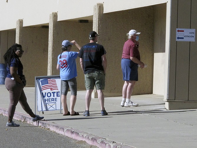 Washoe County voters line up outside a gymnasium at Reed High School in Sparks on June 14, 2022, for Nevada's primary election.