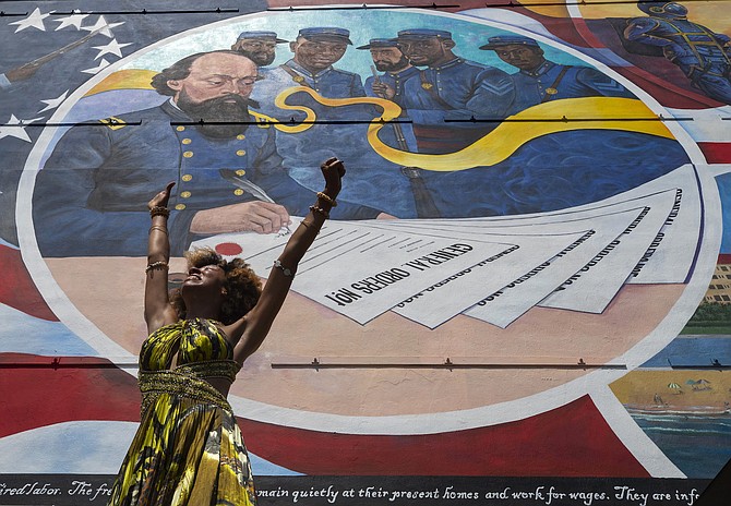 Dancer Prescylia Mae of Houston performs during a dedication ceremony for the mural ‘Absolute Equality’ in Galveston, Texas, on June 19, 2021.
