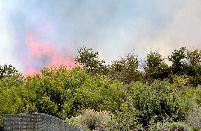 A fire burns above the Genoa Cemetery on June 17, 2022.