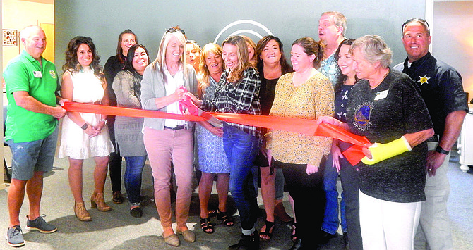 Chamber and Family Support Council members gather as President Tara Addeo and Program Director Jenn Forzani cut the ribbon marking the council’s 40th anniversary. Addeo is also associate publisher of The Record-Courier.