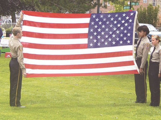 Douglas County Explorers display the flag donated to the Family Support Council by North Bay Industries — an organization that makes handmade flags and employs individuals with disabilities