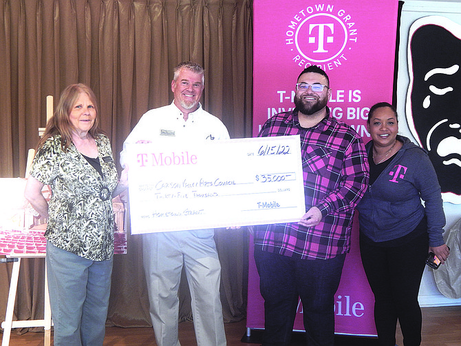 Carson Valley Arts Council Executive Director Sharon Schlegel and President Brian Fitzgerald receive a $35,000 check from T-Mobile Rural Manager Ed Romero and Director of Engineering Cia Parker.