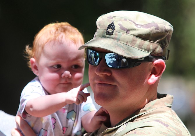 Sgt. 1st Class Daniel, first sergeant with the 137th Military Police Co., holds his niece after a Monday deployment ceremony.