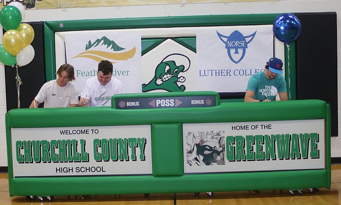 Signing their letters of intent to play college football are, from left, Reece Kincaid and Damien Nestlerode, Feather River College, and Xavier Capton, Luther College.