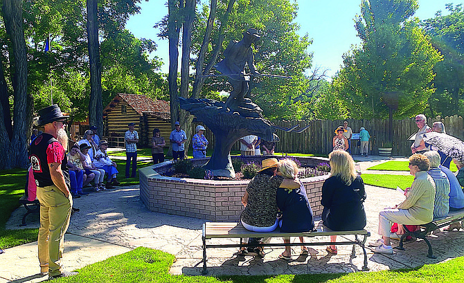 Visitors gather around Snowshoe Thompson’s statue at Mormon Station State Historic Park.