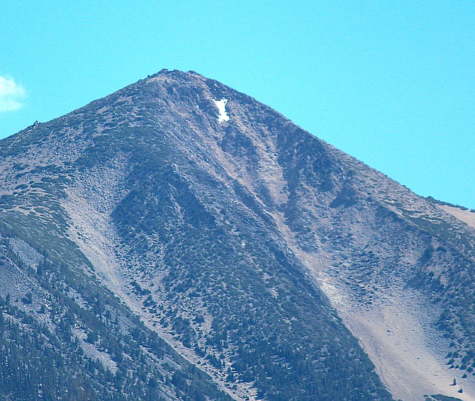 One of the last two patches of snow clings to the crags of Jobs Peak on Thursday afternoon.
