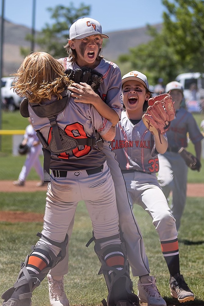 Colt Herald, middle, of the Carson Valley Little 12u All-Stars jumps into the arms of catcher, Brock Tholen while Alejandro Nuno comes to join in the celebration. The CVLL 12u all-stars defeated Washoe, 1-0, to qualify for state.