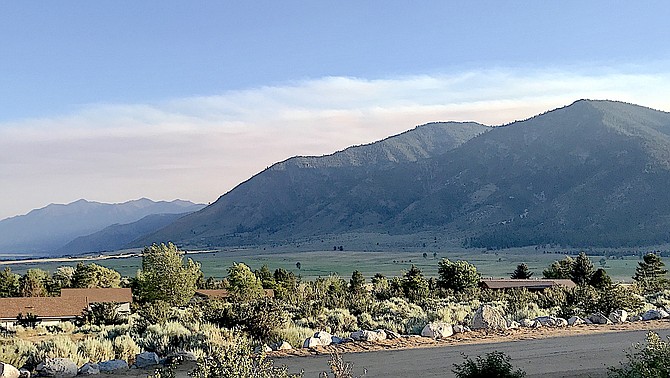 Smoke hovers over the Carson Range on Monday threatening to come back over the Sierra as seen from Alpine View. Photo by Connie Holloway