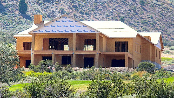A large home under construction above Jacks Valley Road.