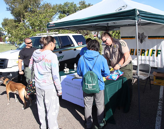 Sheriff Richard Hickox hands out material during a previous Community Days event.