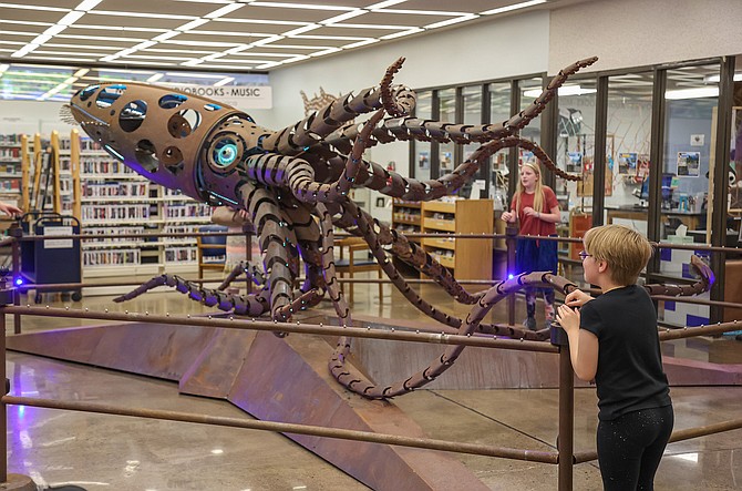 Kegan, 8, interacts with the Mechateuthis Giant Squid installation during the Carson City Library’s Summer Learning Launch party on June 11.
