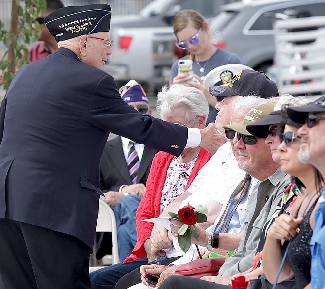 Hershel “Woody” Williams, left, a Medal of Honor recipient from World War II, shakes hands with the crowd at the at the 2019 dedication of the Gold Star Families Memorial in Sparks.