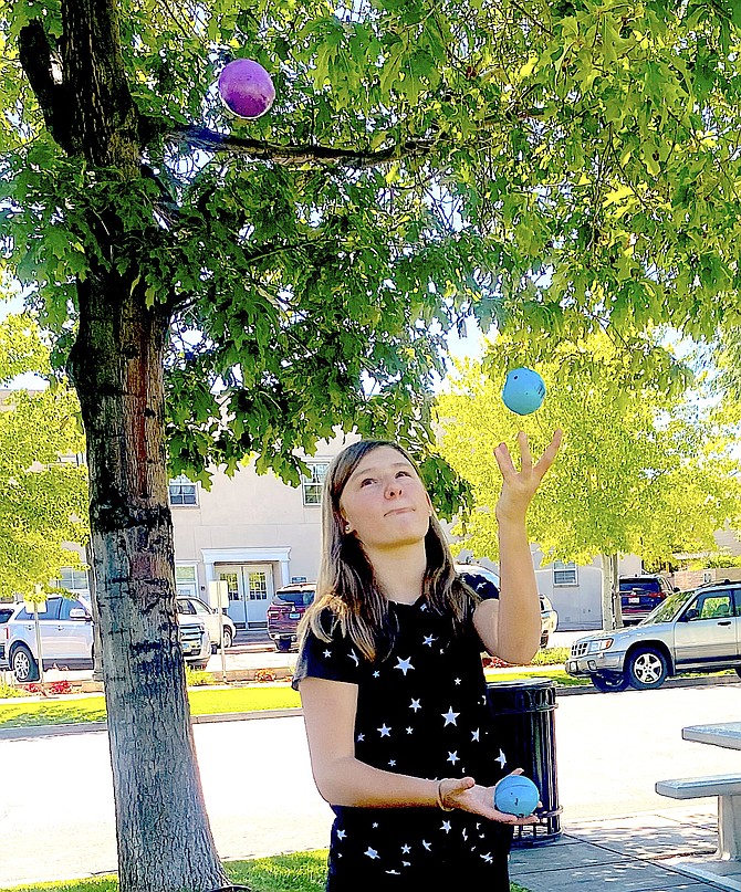Luci Kruger seems to be getting the hang of juggling at a  4-H event in Minden Park on Thursday.