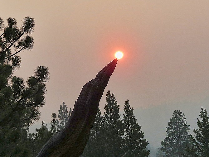 A wooden seal balances the orange ball that is the sun on its nose on Sunday morning in Hope Valley. John Flaherty photo