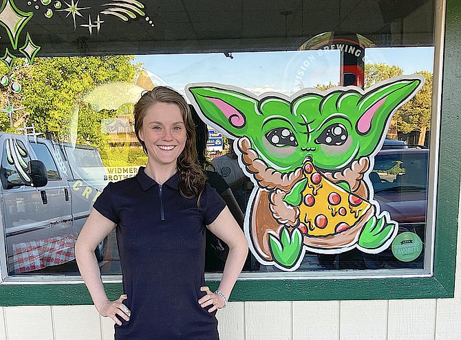 Lowri McGill painted Baby Yoda on a window of Chicago Mike’s Pizza recently.