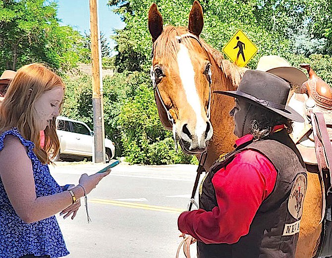 R-C intern Haley Estabrook interviews a Pony Express rider in Genoa on June 15. Haley, who graduated from Douglas High last year, is a journalism student at Arizona State University. Photo  by Genoa resident Anginette VanGelderen.
