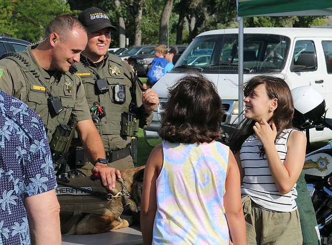 Carson City Sheriff’s Deputy Nick Simpson, left, and Deputy Dylan Etchegaray answer questions about K-9 Ben at Sheriff’s Night Out on Aug. 2, 2022.