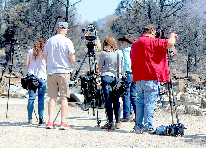 Television crews prepare for a July 28, 2021, press conference in front of the foundation of a home lost in the Tamarack Fire above Holbrook Junction.