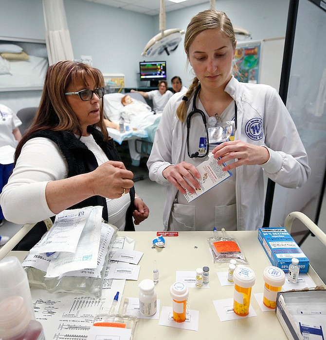 Western Nevada College Nursing Professor Deborah Ingraffia-Strong helps student Julia Guier in a nursing lab in Carson City.
