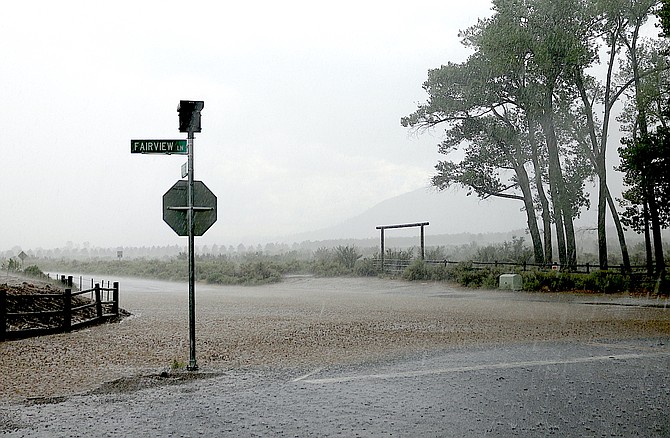 Raindrops splash on Fairview Lane at the intersection with Fredericksburg on Thursday afternoon as heavy rain fell in southern Carson Valley.