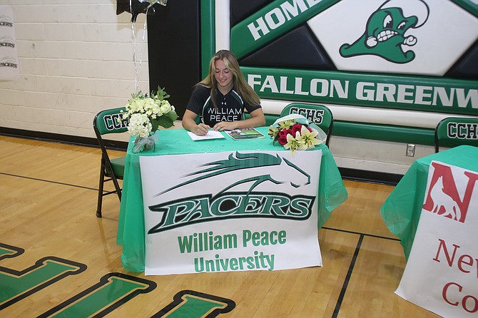 Fallon grad Rachel Mori signs her letter to continue playing softball at William Peace University.