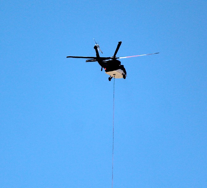 A helicopter flies from Voltaire Canyon in Carson City on July 10, 2022.