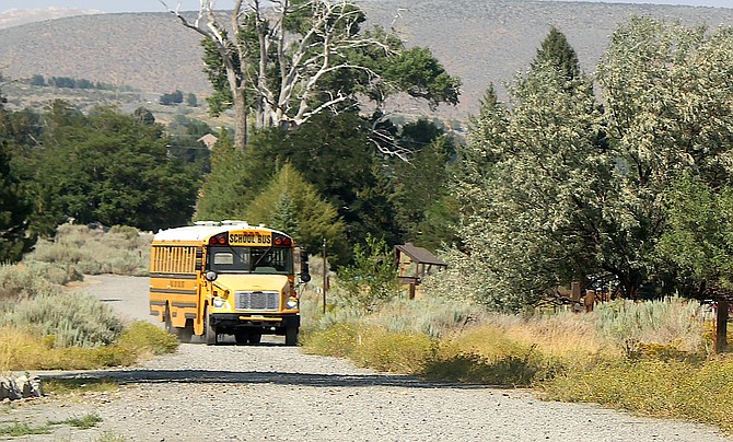 A Douglas County School bus navigates a dirt road in Genoa.