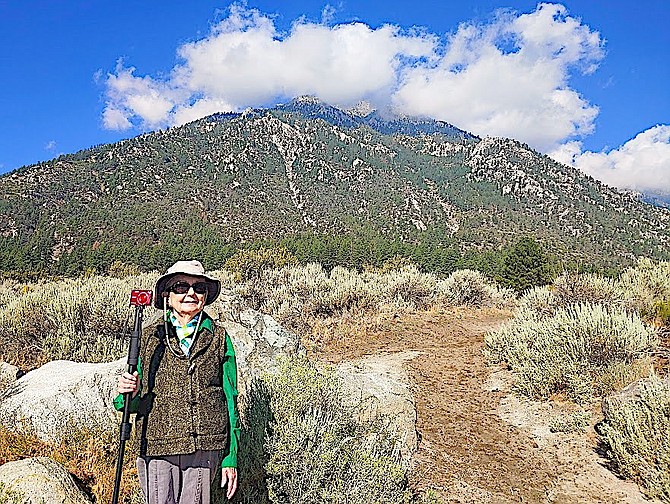 Bonnie Ryan stands at the base of a mountain.