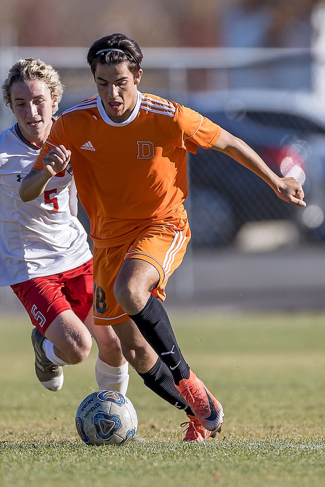 Alex Diaz dribbles up the field during a contest against Truckee last season. Diaz is one of three senior captains for the Douglas High boys’ soccer team this season.