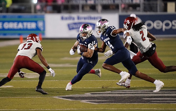 Nevada's Toa Taua breaks free for a touchdown against New Mexico State on Oct. 9, 2021 at Mackay Stadium.
