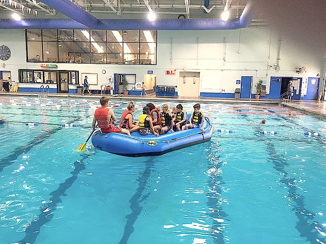 Participants in water safety training paddle around at the Carson Valley Swim Center.