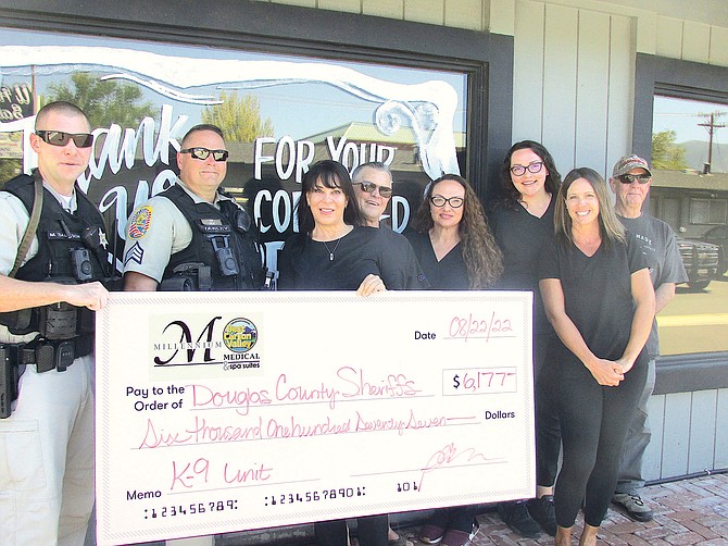 Millennium Medical and Spa Suites presented a check to the Douglas County Sheriff’s Office K-9 Unit Monday. Pictured left to right, Deputy Matt Sampson, Deputy Dave Sampson, Pam Horton, Robert Trumbly, Amy Vidaurri, Savannah Haase, Katie Storke and Gary Marshall.